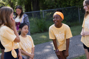 a Camp GOTR participant smiles in a yellow shirt 